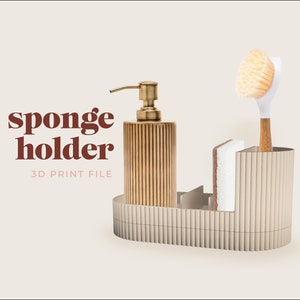 May include: A 3D printable sponge holder with a ribbed design. The holder has a compartment for a soap dispenser, a sponge, and a brush. The text "sponge holder 3D PRINT FILE" is printed below the holder.