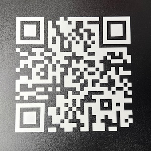 May include: A black and white QR code on a black background.