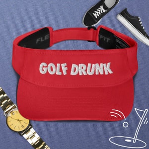 May include: Red golf visor with white embroidered text "GOLF DRUNK".