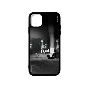 May include: Black phone case featuring a black and white image with the word "petal" in the center. The design includes a grayscale photo of a person's face and legs wearing a black high heel shoe.