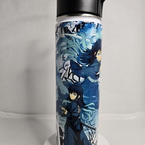 May include: A stainless steel water bottle with a black lid and a carrying strap. The bottle features a colorful anime design with blue, white, and black characters.