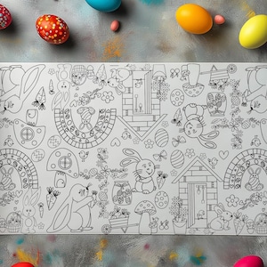 May include: A roll of white paper with a black and white Easter-themed coloring page. The design features bunnies, eggs, carrots, flowers, and houses. Colourful Easter eggs are scattered around the paper on a grey surface.