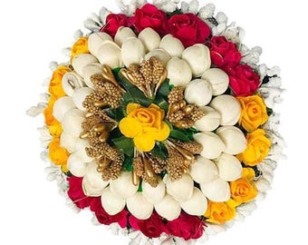 May include: A white, yellow, and red flower hair clip with a cluster of white flowers in the center surrounded by yellow and red roses.