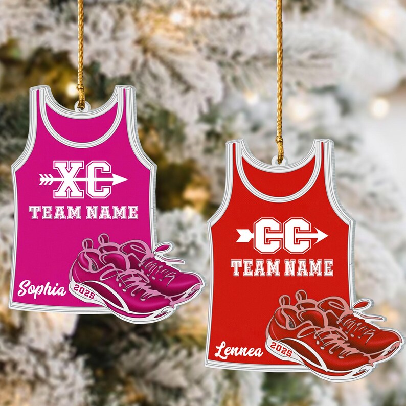 May include: Two athletic ornaments. One is a pink tank top with "XC" and an arrow, the other is a red tank top with "CC" and an arrow. Both have "TEAM NAME" text. Each ornament has a pair of running shoes and a name and year.