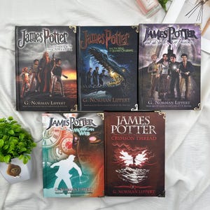 May include: A collection of five hardcover books with the title "James Potter" on the covers. The books feature illustrations of characters and scenes, with titles like "The Curse of Catertiter" and "Crimson Thread."