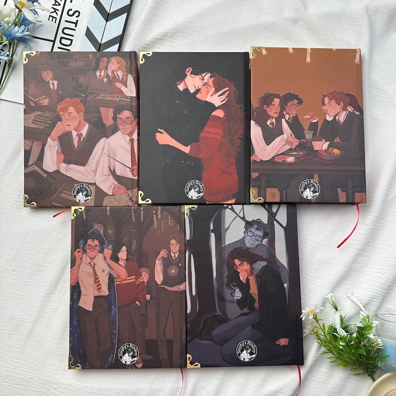May include: Five hardcover books with illustrations of characters in various scenes. The book covers feature detailed artwork with gold corner protectors and red ribbon bookmarks. The illustrations depict people in different settings.