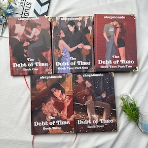May include: A collection of five books titled "The Debt of Time" with various cover illustrations. The covers feature couples in romantic settings, with text including "shayalonnie" and book numbers. The books are arranged on a white surface.