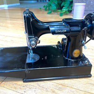Vintage 1948 Singer Featherweight sewing machine in good working condition.