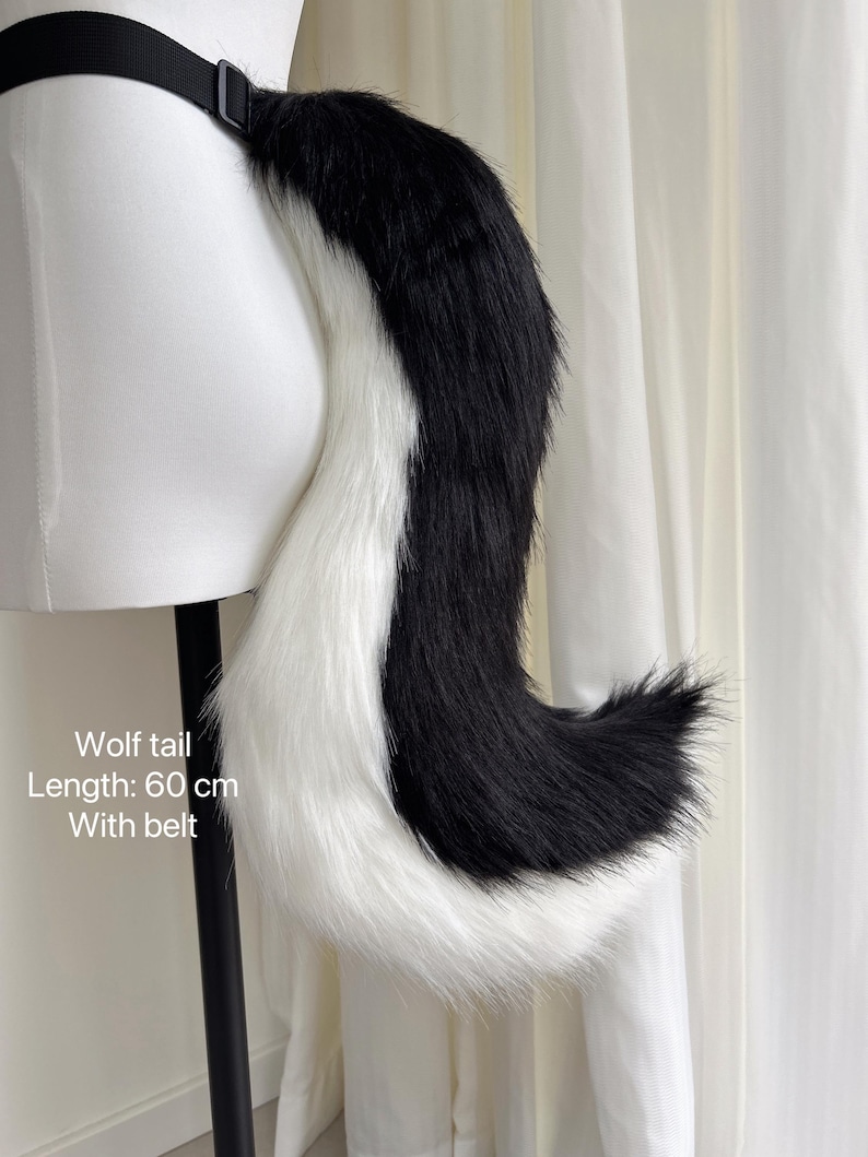 May include: Black and white wolf tail with a white tip. The tail is attached to a black belt. Wolf tail, Length: 60 cm, With belt.