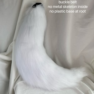 May include: A white faux fur tail with a black buckle belt. The tail is 70 inches long and has no metal skeleton or plastic base.
