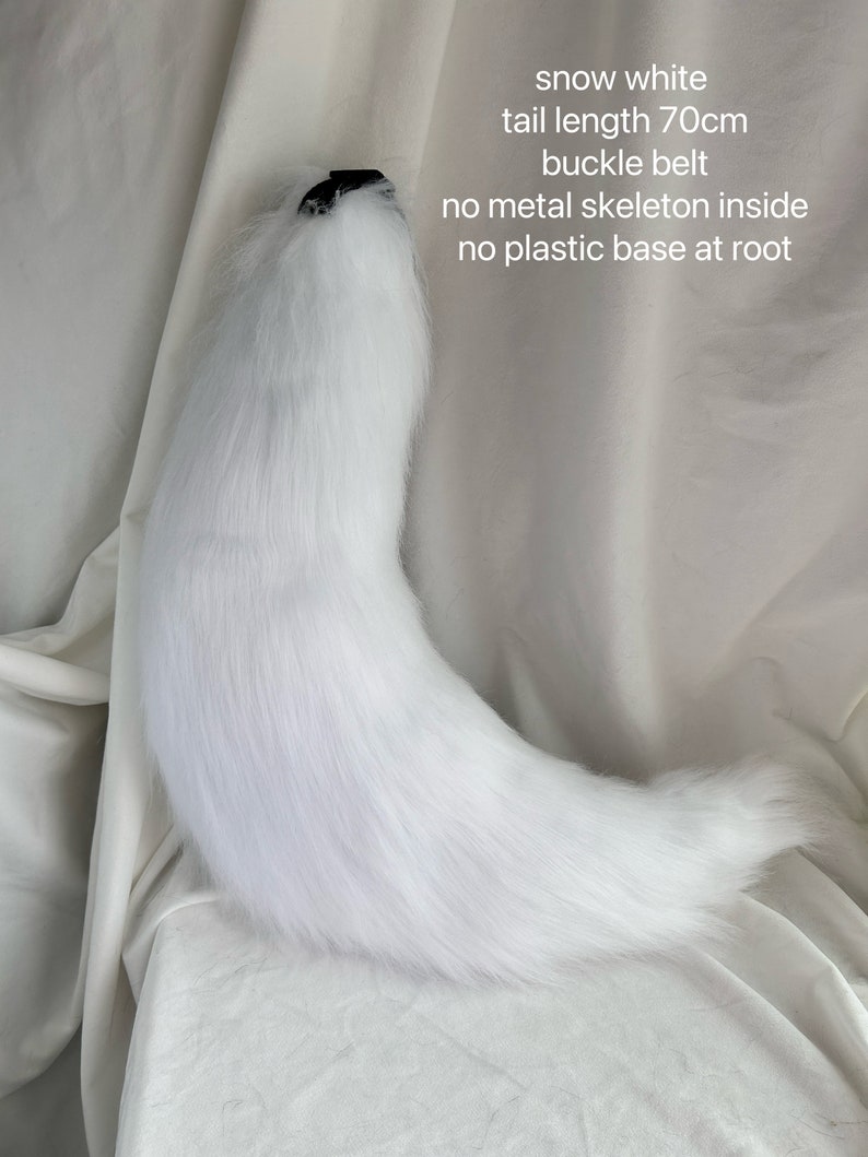 May include: A white faux fur tail with a black buckle belt. The tail is 70 inches long and has no metal skeleton or plastic base.