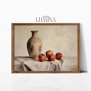 May include: A framed painting of a still life with a brown ceramic vase and red apples on a white tablecloth. The painting is titled "Galeria Lumina".