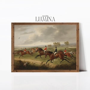 May include: A framed painting depicting a group of riders on horseback in a field. The riders are dressed in red jackets and black hats, and the horses are brown. The painting is set against a cloudy sky and a green field.