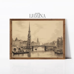 May include: A sepia-toned print of a city scene with a tall church steeple and a bridge over a canal. The print is framed in a wooden frame.