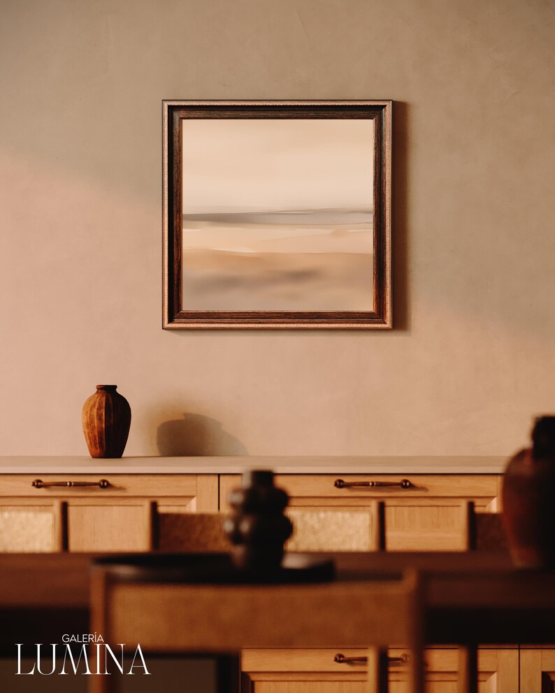 Pode incluir: Uma pintura de paisagem emoldurada com uma moldura de madeira marrom est&aacute; pendurada acima de um arm&aacute;rio de madeira. Um vaso marrom est&aacute; sobre o arm&aacute;rio. A pintura retrata uma cena de praia com cores neutras. A palavra "GALERIA LUMINA" est&aacute; na parte inferior.