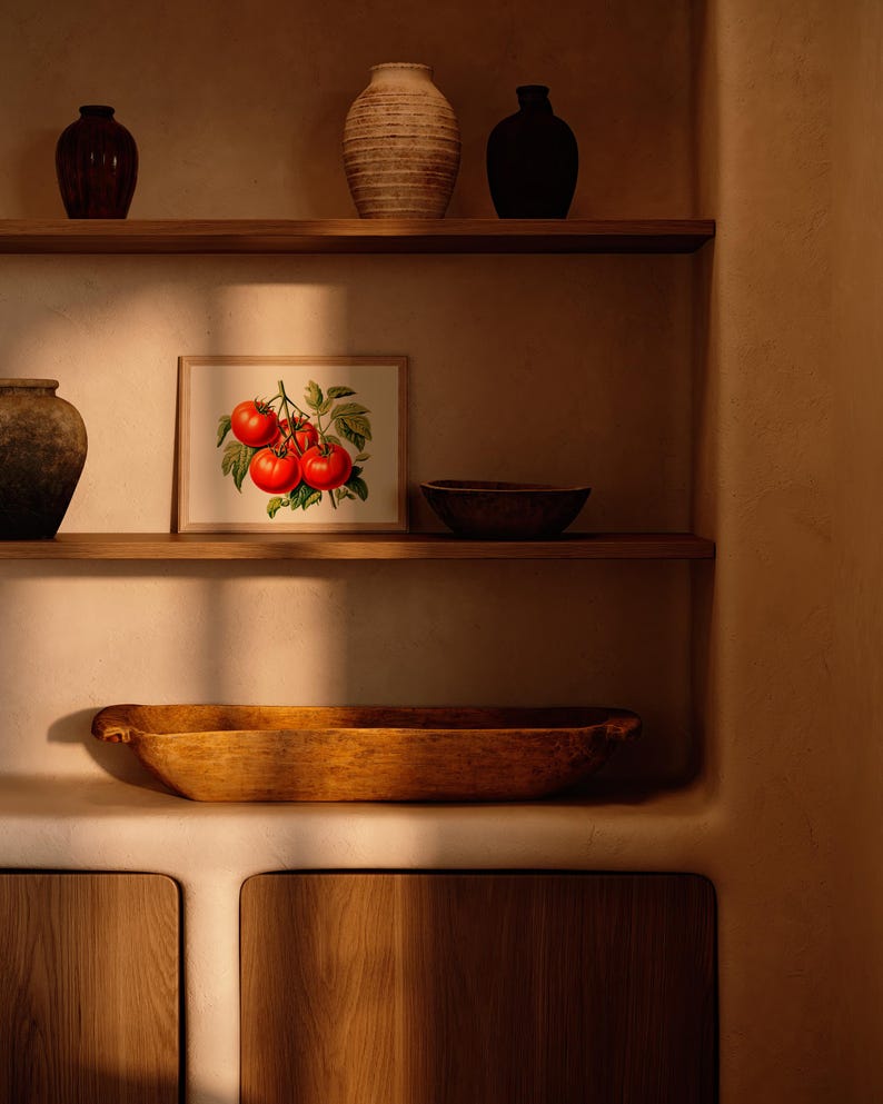 May include: A rustic kitchen scene featuring wooden shelves with various decorative items. A framed botanical print of tomatoes hangs between shelves. Other items include vases, a wooden bowl, and a large wooden trough.