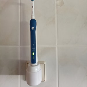 Oral B electric toothbrush holder charging station wall socket image 3