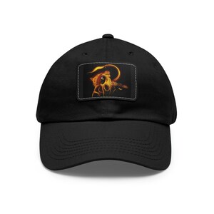 May include: Black baseball cap with a patch featuring a stylized image of a Hindu deity in a fiery orange and yellow color scheme.