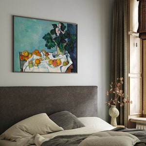 a bed in a bedroom with a painting on the wall