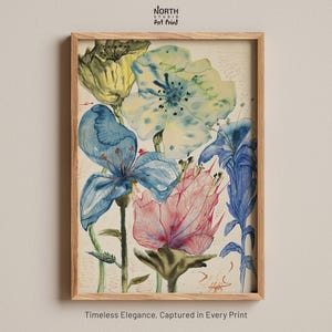 May include: A framed art print featuring a watercolor illustration of various flowers in shades of blue, yellow, and pink. The artwork displays delicate petals and stems against a light background. The text North Studio Art Print appears at the top.