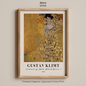 May include: A framed art print of Gustav Klimt's "Portrait of Adele Bloch-Bauer I" from 1907. The artwork features a woman in a gold dress with intricate patterns. The print is in a wooden frame, with the text "NORTH STUDIO Art Print" at the top.