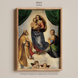 May include: A framed art print of a Renaissance painting. The image shows a central female figure holding a child, with other figures and cherubs. The painting uses blues, reds, and golds. The frame is light-coloured wood. Text at the bottom reads: "Timeless Elegance, Captured in Every Print."