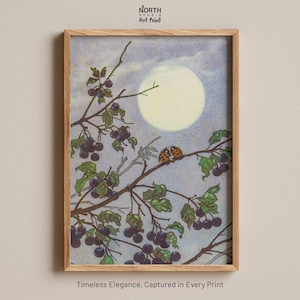 May include: A framed art print featuring a light-colored moon in a pale blue sky behind branches laden with dark purple berries and two ladybugs. The text North Studio Art Print appears at the top, and Timeless Elegance, Captured in Every Print at the bottom.