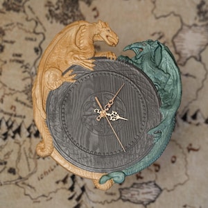 May include: A decorative clock featuring a detailed design with two dragons flanking the clock face. One dragon is gold, the other is green. The clock face is dark gray with gold clock hands. The background is a map.