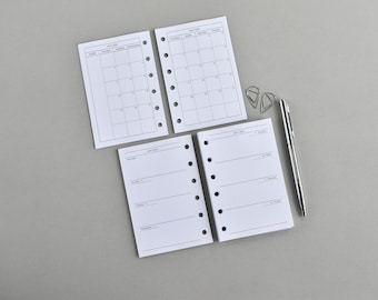May include: Four white planner inserts with black text and grid lines for May 2024, featuring six-hole punches along the side. Two sheets show a monthly calendar view, while two show a weekly layout. A silver metal pen and two silver paper clips are included.