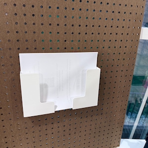 May include: A set of three ceramic mugs with a speckled, cream-colored glaze. Each mug features a different hand-painted floral design in shades of blue, green, and yellow. The mugs have a simple, rounded shape and a comfortable handle.