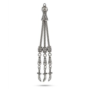 May include: A silver-toned pendant featuring a decorative design. The pendant has a braided top, three strands, and small dagger-shaped charms at the bottom. The design is symmetrical and detailed, with a vintage or antique aesthetic.