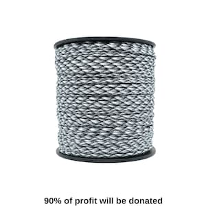 Puede incluir: Un carrete de paracord de camuflaje negro y blanco.