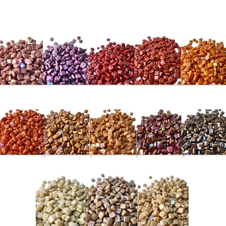 May include: A collection of small, square mosaic tiles in various colors, including shades of brown, purple, red, and gold. The tiles are arranged in rows, showcasing the range of hues and textures available for crafting projects.