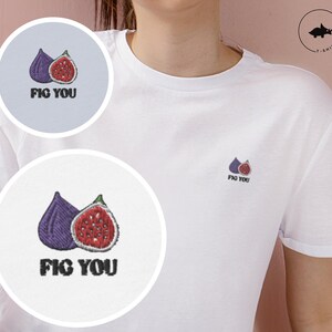 May include: White t-shirt with a purple and red fig embroidered on the front. The text "FIG YOU" is embroidered below the fig.