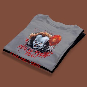 May include: A gray t-shirt with a graphic of Pennywise the clown from the movie "IT". The graphic shows Pennywise holding a red balloon with the text "You'll Float Too!" in red.