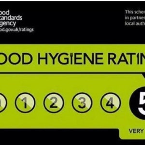 May include: A green and black food hygiene rating sticker with a white number 5 in a black circle. The text "VERY GOOD" is below the number. The sticker is from the Food Standards Agency.