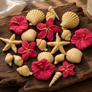 May include: A collection of decorative items including cream-coloured seashells, starfish, and vibrant pink hibiscus and plumeria flowers. The assortment features various shell shapes, including spiral and fan-like designs, arranged together.