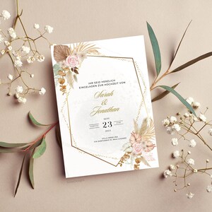 May include: A wedding invitation with a gold geometric frame and floral accents. The invitation reads "IHR SEID HERZLICH EINGELADEN ZUR HOCHZEIT VON Sarah & Jonathan SEPT 23 2023 VILLA ORSELINA VIA SANTUARIO 10, 6844 LUGANO"