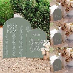 May include: A set of three arch-shaped welcome signs for a wedding. The signs are made of sage green acrylic and feature white calligraphy. The signs read "Hut", "Bienvenue a la ceremonie de Charlotte & Nicolas 22.06.2024", and "Trouvez votre place".
