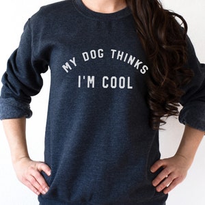 May include: A dark blue sweatshirt with the text "My dog thinks I'm cool" printed in white.
