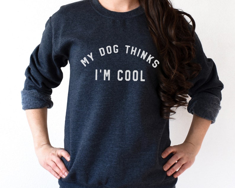 May include: A dark blue sweatshirt with the text "My dog thinks I'm cool" printed in white.