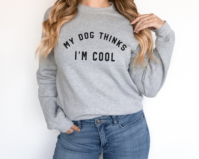 May include: A gray sweatshirt with the text "My dog thinks I'm cool" printed on the front.
