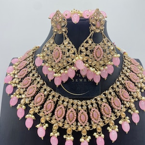 Pink kundan choker necklace with marching earrings and Maang tikka