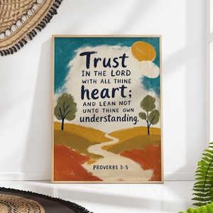 May include: A rectangular wall art print in a light wood frame featuring a landscape painting with rolling hills in shades of yellow, orange, and green. The text reads: Trust IN THE LORD WITH ALL THINE heart; AND LEAN NOT UNTO THINE OWN understanding. PROVERBS 3:5.