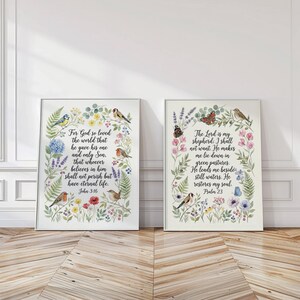May include: Two framed art prints with floral and bird illustrations. The left print features text from John 3:16, while the right print displays Psalm 23. Both prints have a white background and are surrounded by colourful flowers and greenery.