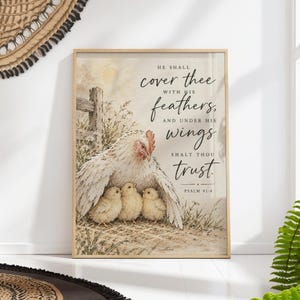 May include: A framed wall art print featuring a watercolour illustration of a white hen sheltering three yellow chicks under her wings. The text reads: He shall cover thee with his feathers, and under his wings shalt thou trust. Psalm 91:4.