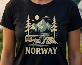 Op de afbeelding: Een zwart t-shirt met een grafische print van een kampeerscène met een busje, een tent, dennenbomen, bergen en een zon. Het woord NORWAY is in grote, dikke, crèmekleurige hoofdletters onderaan het grafische ontwerp gedrukt.
