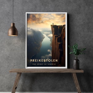 May include: A poster with a photograph of a person standing on the edge of a cliff overlooking a fjord. The text "Preikestolen The Spirit of Norway" is at the bottom of the poster.