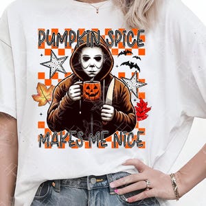 May include: White t-shirt featuring a graphic of a figure in a Michael Myers mask holding a pumpkin spice latte and a knife. The text reads "PUMPKIN SPICE MAKES ME NICE" with fall-themed accents.