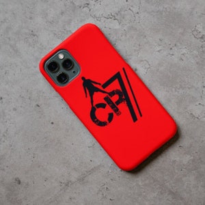 May include: Red phone case with a black silhouette of a soccer player and the text "CR7" printed on it.